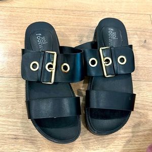 Black platform sandals with gold accents